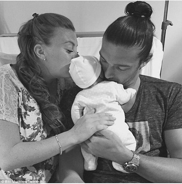 Baby joy: Billi Mucklow and Andy Carroll cuddle their new baby boy following his birth on Monday in a candid Instagram shot