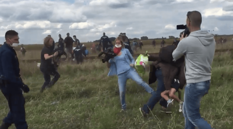 A camerawoman for the Hungarian broadcaster N1TV tripped a man with a child in his arms who was fleeing from police at a migrant camp near the Serbian border on Tuesday. Credit Stephan Richter, via Twitter