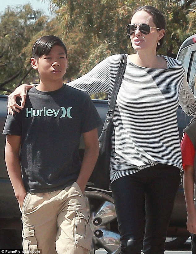 Holiday mishap: Brad Pitt and Angelina Jolie's son Pax, 12, injured his right leg while on family vacation in Thailand, People reported; here they are seen in July