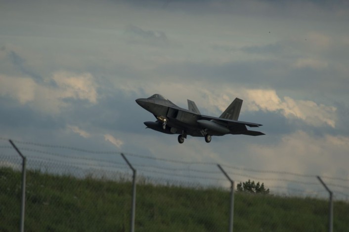 An F-22 Raptor fighter aircraft assigned to the 95th Fighter Squadron at Tyndall Air Force Base, Fla., prepares to land on the runway at Spangdahlem Air Base, Germany, Aug. 28, 2015. The U.S. Air Force deployed four F-22s, one C-17 Globemaster III and more than 50 Airmen to Spangdahlem in support of the first F-22 European training deployment. The inaugural F-22 training deployment to Europe is funded by the European Reassurance Initiative, a $1 billion pledge announced by President Obama in March 2014. (U.S. Air Force photo by Airman 1st Class Luke Kitterman/Released)