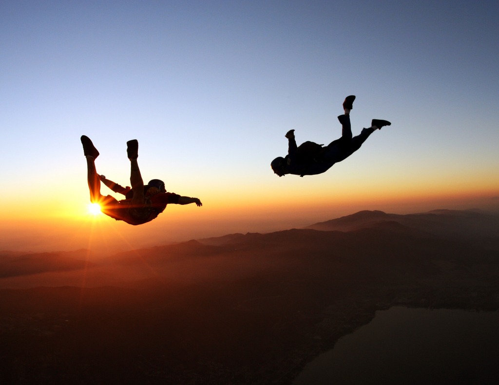 Skydivers jumping at the amazing sunset