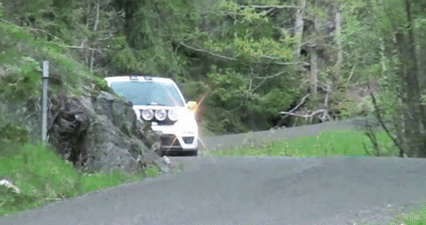 funny fail gif rally car loses tire on turn and hits cameraman
