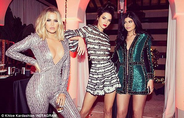 Va-voom Khloe: At Jenner's bash, the Strong Looks Better Naked author looked stunning in a low-cut jumpsuit that flashed her cleavage and made the most of her slender waistline; here she is seen with Kendall and Kylie