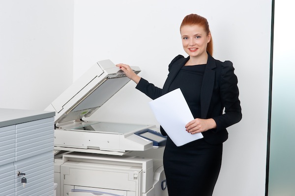 business woman working on office printer