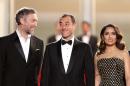 Actor Vincent Cassel, left, speaks with director Matteo Garrone, as they arrive with actress Salma Hayek for the screening of the film Tale of Tales at the 68th international film festival, Cannes, southern France, Thursday, May 14, 2015. (AP Photo/Thibault Camus)
