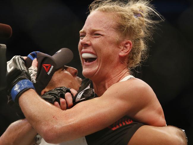 Holm celebrates her win against Ronda Rousey at UFC 193.