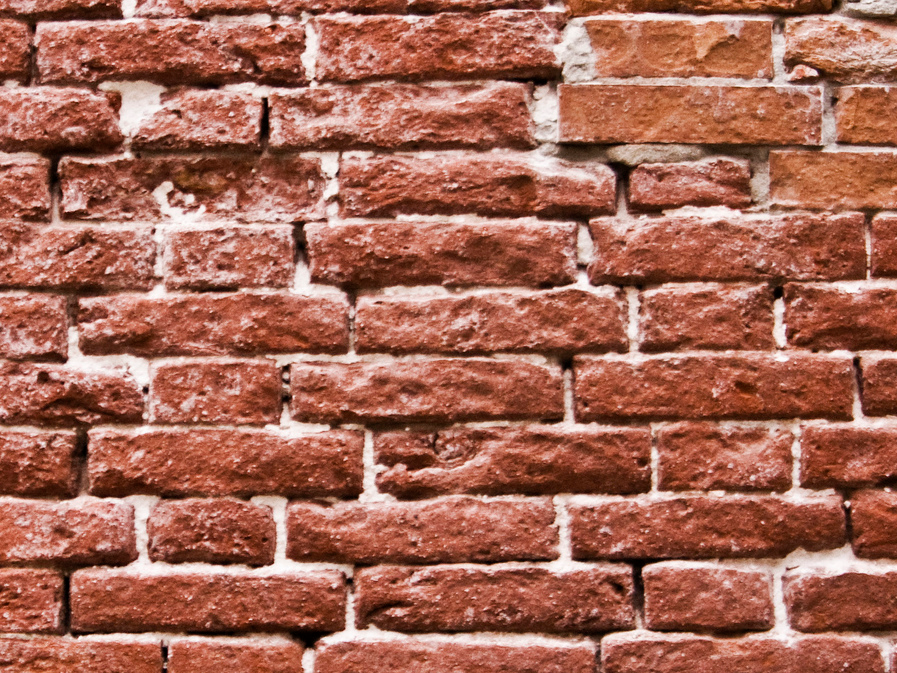red brick wall kid nose picking
