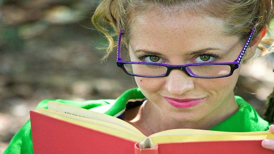 Girl with glasses holding a book