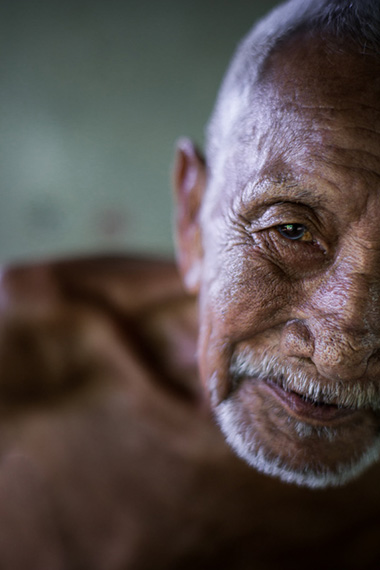 A close up portrait of an old man in Laos