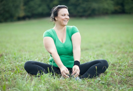 Happy Woman Stretching in Field