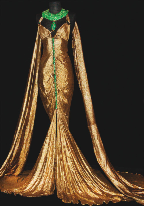 Travis Banton design of a Gold lamé gown with gilt and emerald...