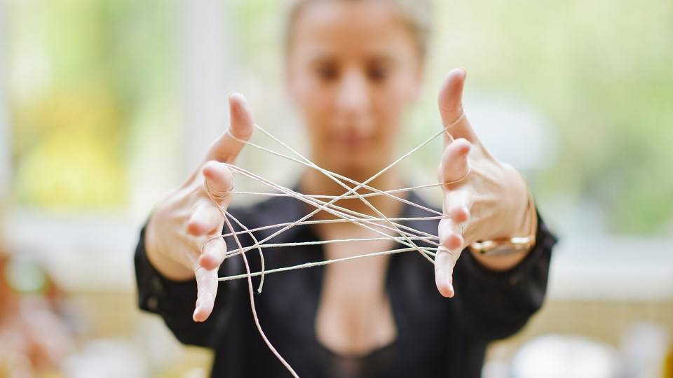 Womans hands connected With Tangled String2