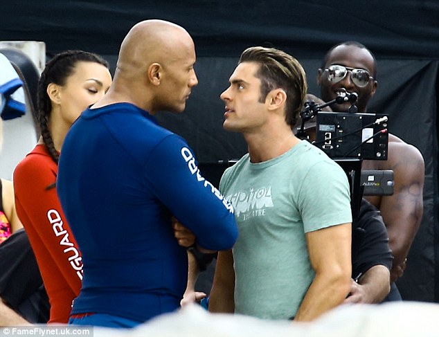 There's a problem: Efron and The Rock eyeballed each other as they exchanged words