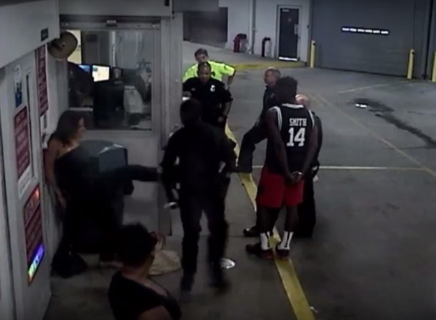 In the video, Borisade, who was one of the arresting officers, is seen physically restraining the handcuffed woman against the wall. She then attempts to kick him twice.