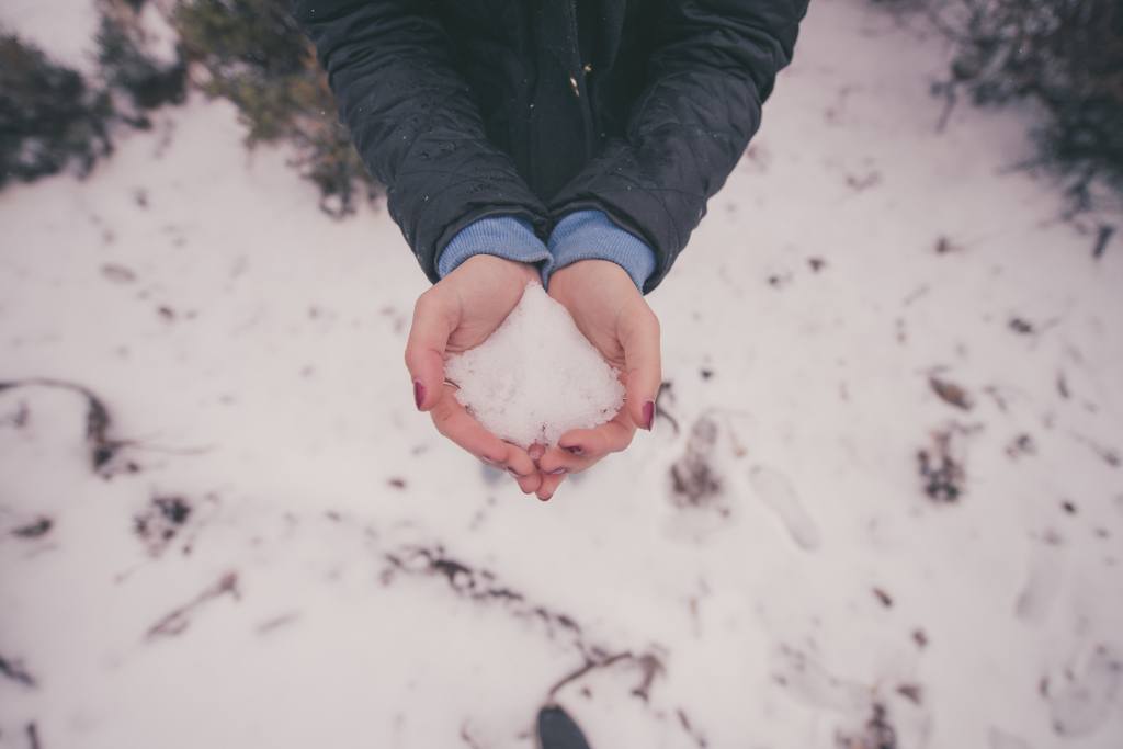Girl Holding Winter Snow In Hands