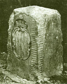 A "crownstone" boundary monument on the Mason–Dixon line. These markers were originally placed at every 5th mile along the line, ornamented with family coats of arms facing the state that they represented. The coat of arms of Maryland's founding Calvert family is shown. On the other side are the arms of William Penn.