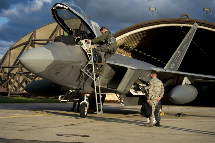 An F-22 Raptor fighter aircraft pilot assigned to the 95th Fighter Squadron at Tyndall Air Force Base, Fla., exits an F-22 at Spangdahlem Air Base, Germany, Aug. 28, 2015. The U.S. Air Force deployed four F-22 Raptors, one C-17 Globemaster III and more than 50 Airmen to Spangdahlem in support of the first F-22 European training deployment. The inaugural F-22 training deployment to Europe is funded by the European Reassurance Initiative, a $1 billion pledge announced by President Obama in March 2014. (U.S. Air Force photo by Airman 1st Class Luke Kitterman/Released)