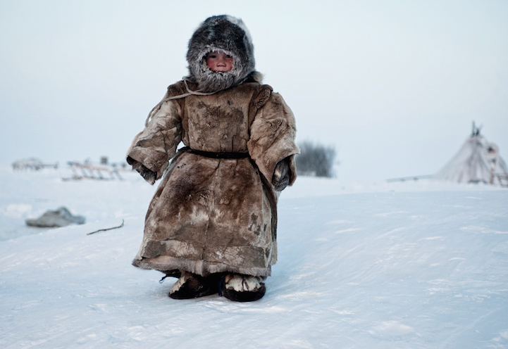 A Young Nenets boy plays in -40 degrees on Yamal in the Winter in Siberia.