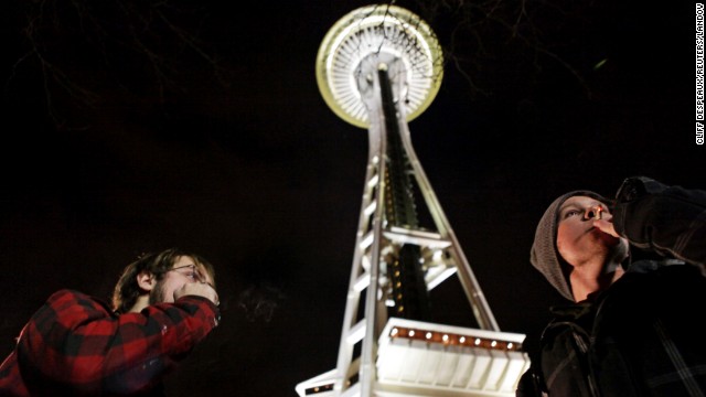 People light up near the Space Needle in Seattle after the law legalizing the recreational use of marijuana went into effect in Washington on December 6, 2012.