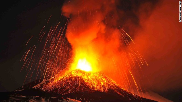 Mount Etna, as seen from the town of Acireale, Italy, spews lava during an eruption on November 16, 2013.
