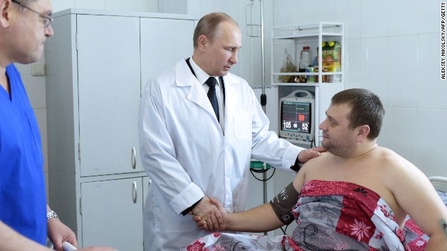 Putin visits a hospital in Volgograd on New Year's Day to visit survivors of two explosions in the city which have called into question security at the 2014 Winter Games.