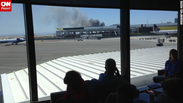 iReporter Val Vaden captured this photo while waiting in a departure lounge at the San Francisco airport on July 6. Val observed the billowing smoke and emergency responders' rush in. 