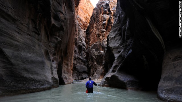 Zion National Park in Utah came in seventh place on the park service's list of most popular national parks. Here, a hiker wades up the Virgin River in the Zion Narrows. 