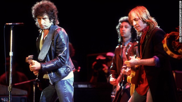 Dylan performs with Tom Petty at Farm Aid in Chicago in 1985.