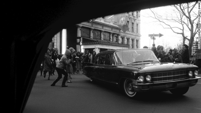 A car belonging to The Beatles is besieged by fans in New York on February 10, 1964.