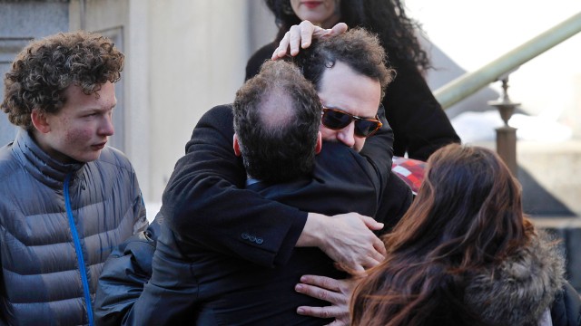 Writer David Bar Katz, wearing glasses, is embraced as he arrives at the church. Katz found Hoffman's body.