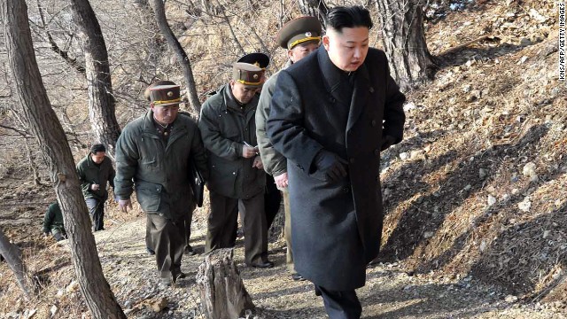 Kim, with North Korean soldiers, makes his way to an observation post on March 25.