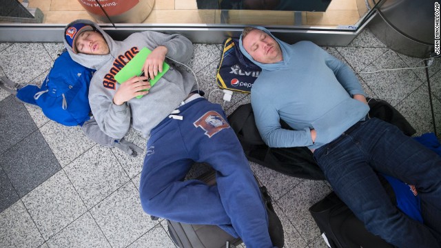 Drew Brown, left, and Matt Robbins sleep on the floor at LaGuardia Airport on February 3 after heavy snow in New York affected their flight. The winter storm stranded thousands of fans trying to head home after the Super Bowl.