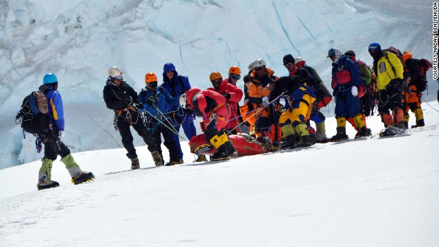 Climbers on Everest work to help someone in distress.