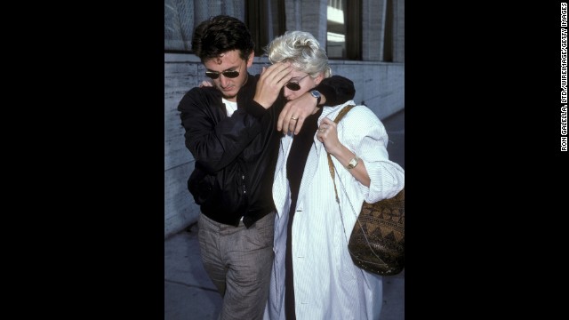 Then-husband Sean Penn shields Madonna from the paparazzi during a lunch break in New York City on August 13, 1986.