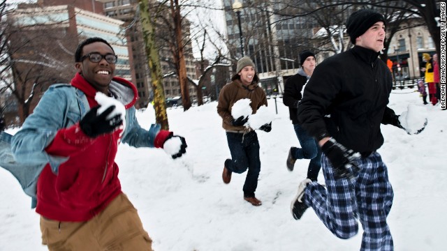 People run before throwing snowballs in the Dupont Circle neighborhood of Washington on February 13.