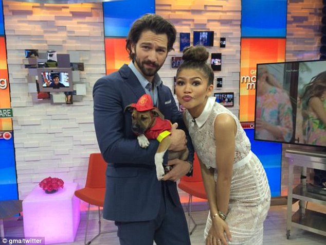 In good company: She made a duck face while posing with Game Of Thrones star Michiel Huisman and a puppy in the studio 