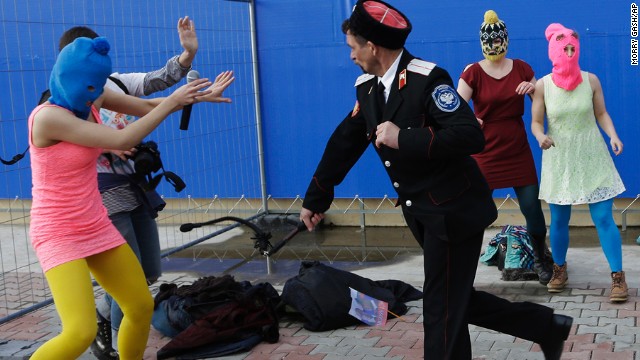 A video appeared to show security officials beating two members of the punk rock protest band Pussy Riot. Two members were held by police just miles from the Olympic Park.