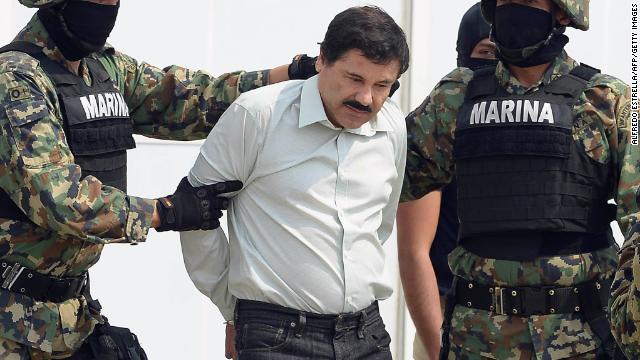 Mexican drug trafficker Joaquin "El Chapo" Guzman is escorted by Mexican marines as he is presented to the press on February 22, in Mexico City. 