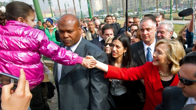 Clinton shakes hands with a child during an unannounced walk through Tahrir Square in Cairo on March 16, 2011.