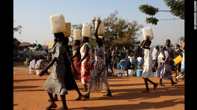 South Sudanese women carry water at a U.N. camp in Juba on December 22. 