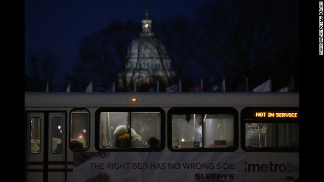 People sleep inside a Metrobus parked at Union Station in Washington on January 22. The bus was designated a warming station for the homeless.