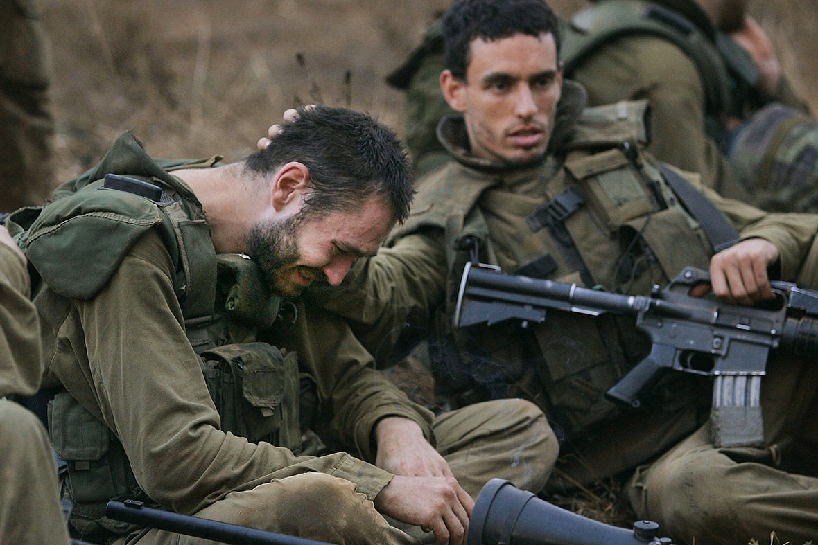 August 14, 2006: An Israeli soldier is overcome with emotion after returning to Israel from Lebanon as a ceasefire is declared following a month of fighting