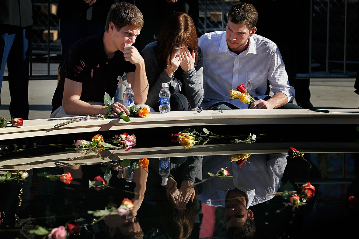 September 11, 2010: Family members grieve in front of a reflecting pool on the ninth anniversary of the 9/11 terrorist attacks in New York City