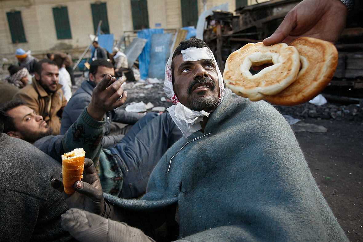 February 6, 2011: Food is offered to a wounded anti-government protester at Tahrir Square in Cairo, Egypt
