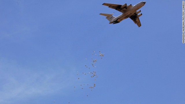 Bags of food are dropped from a plane during a World Food Program operation Tuesday, April 1, in Nyal, South Sudan.