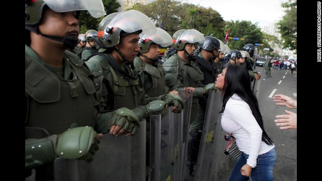 A young woman argues with members of the Venezuelan National Guard during an anti-government protest in Caracas on Monday, February 17.