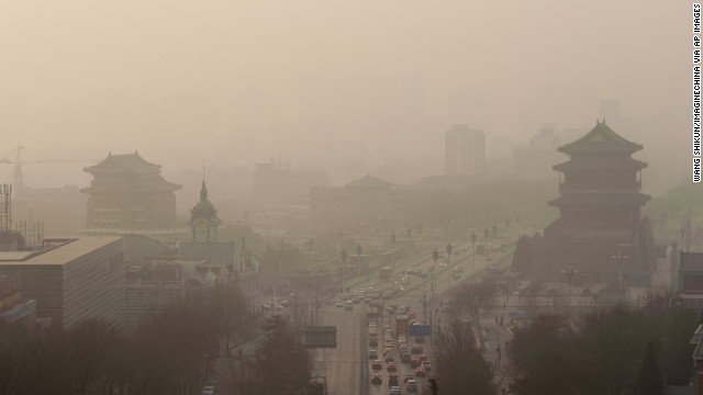 Vehicles move slowly through heavy smog in Beijing on Thursday, January 16. China's manufacturing of exports generates pollution that harms air quality -- not only in Asia but also all the way across the Pacific Ocean in the Western United States, according to a new study. 