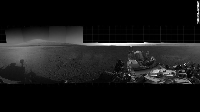 With the addition of four high-resolution Navigation Camera, or Navcam, images, taken on August 18, 2012. Curiosity's 360-degree landing-site panorama now includes the highest point on Mount Sharp visible from the rover. Mount Sharp's peak is obscured from the rover's landing site by this highest visible point. 