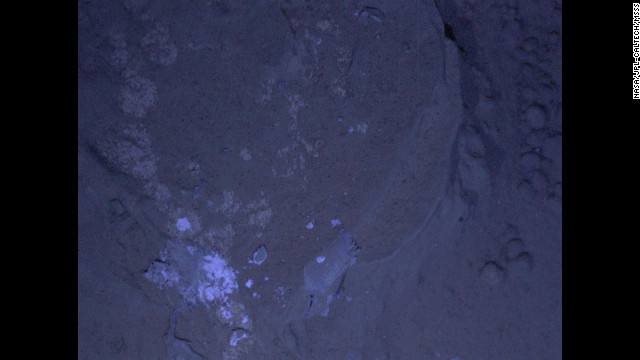 Curiosity's first set of nighttime photos include this image of Martian rock illuminated by ultraviolet lights. Curiosity used the camera on its robotic arm, the Mars Hand Lens Imager, to capture the images on January 22, 2013.