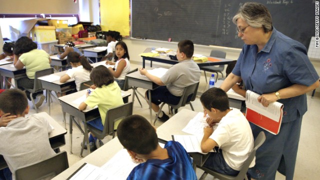 A teacher assists third-grade students in a Chicago classroom. Illinois is one of 45 states that have adopted Common Core.